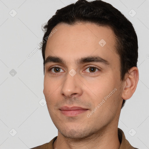 Joyful white young-adult male with short  black hair and brown eyes