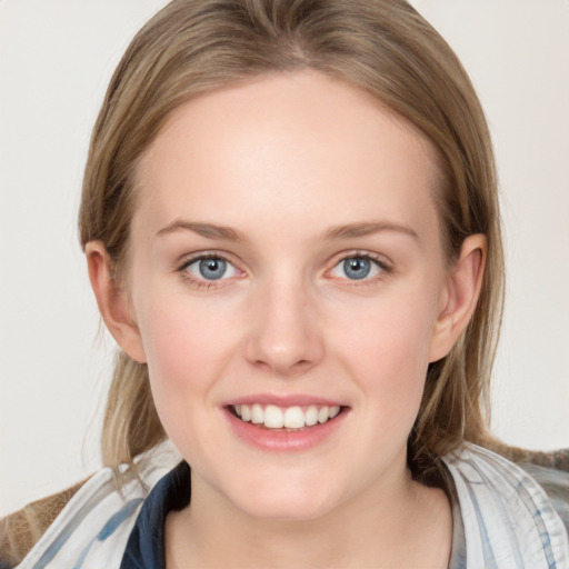 Joyful white young-adult female with medium  brown hair and blue eyes