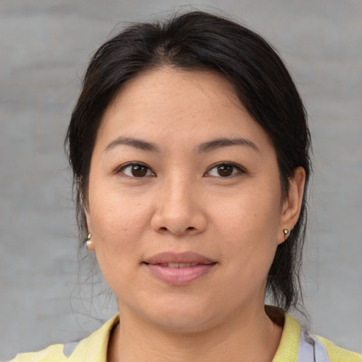 Joyful white adult female with medium  brown hair and brown eyes