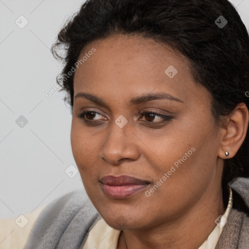 Joyful black young-adult female with short  brown hair and brown eyes