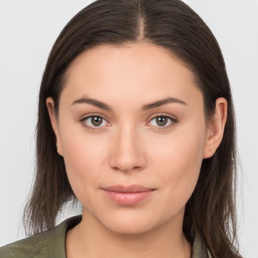 Joyful white young-adult female with long  brown hair and brown eyes