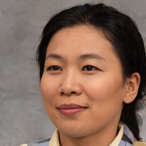 Joyful asian adult female with medium  brown hair and brown eyes