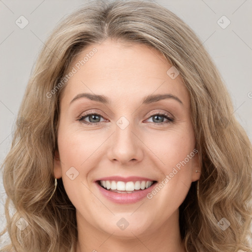 Joyful white young-adult female with long  brown hair and green eyes