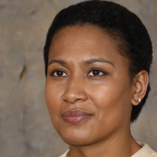 Joyful black young-adult female with short  brown hair and brown eyes