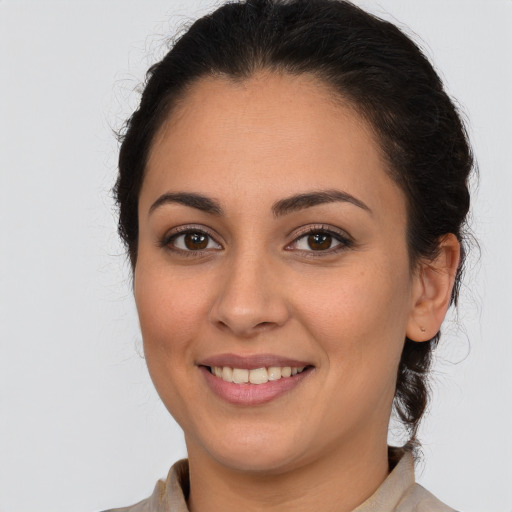 Joyful white young-adult female with long  brown hair and brown eyes