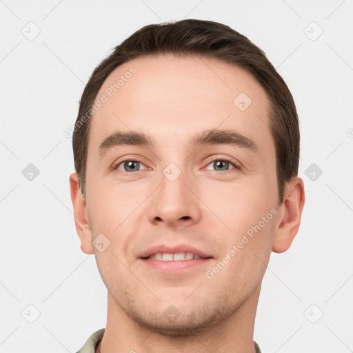 Joyful white young-adult male with short  brown hair and grey eyes