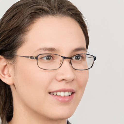 Joyful white young-adult female with medium  brown hair and grey eyes