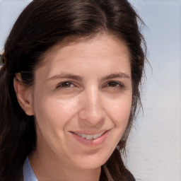 Joyful white adult female with long  brown hair and brown eyes