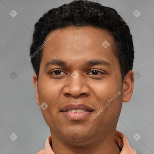Joyful black young-adult male with short  black hair and brown eyes