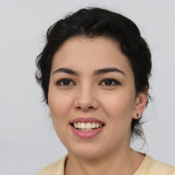 Joyful latino young-adult female with medium  brown hair and brown eyes