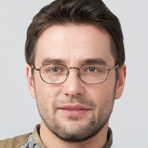 Joyful white young-adult male with short  brown hair and grey eyes