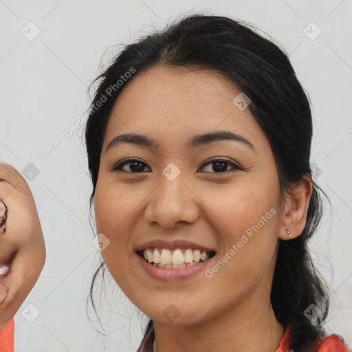 Joyful asian young-adult female with medium  black hair and brown eyes