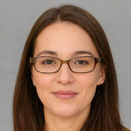 Joyful white adult female with long  brown hair and brown eyes