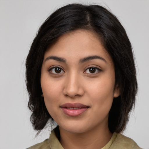 Joyful latino young-adult female with medium  brown hair and brown eyes