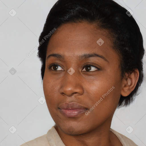 Joyful black young-adult female with short  black hair and brown eyes