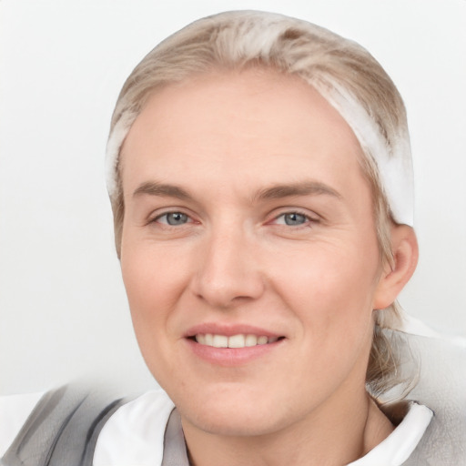 Joyful white adult female with short  brown hair and grey eyes