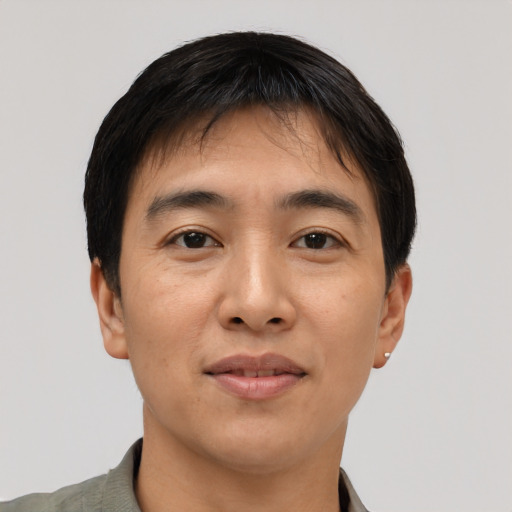 Joyful asian young-adult male with short  black hair and brown eyes