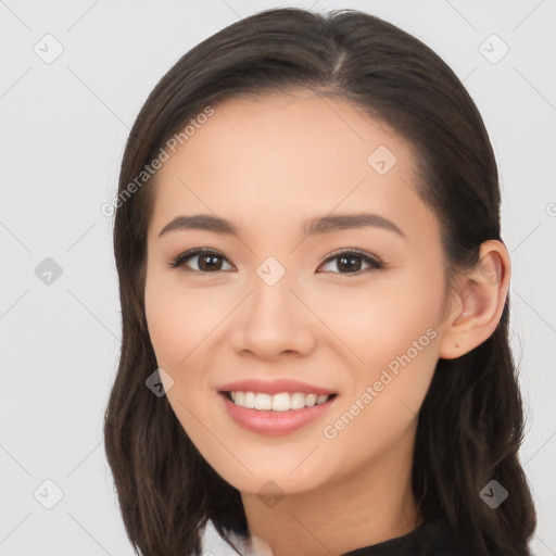 Joyful asian young-adult female with long  brown hair and brown eyes