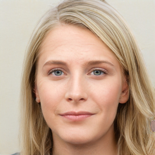 Joyful white young-adult female with long  brown hair and blue eyes