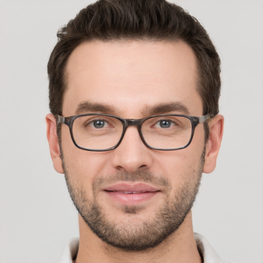 Joyful white young-adult male with short  brown hair and brown eyes