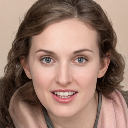 Joyful white young-adult female with long  brown hair and blue eyes