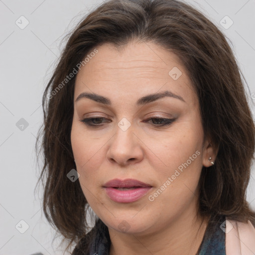 Joyful white adult female with long  brown hair and brown eyes