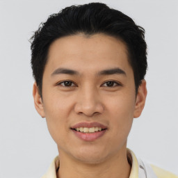 Joyful asian young-adult male with short  black hair and brown eyes