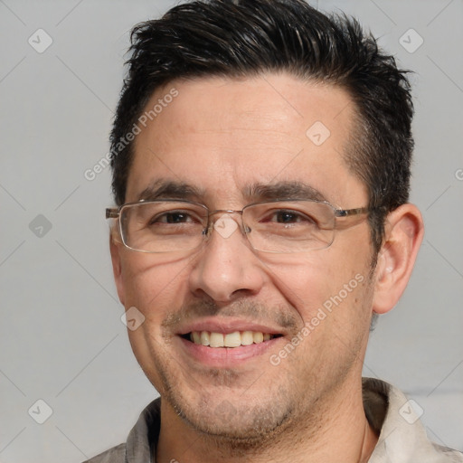 Joyful white adult male with short  brown hair and brown eyes