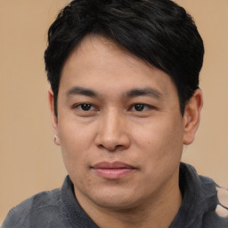 Joyful asian young-adult male with short  black hair and brown eyes