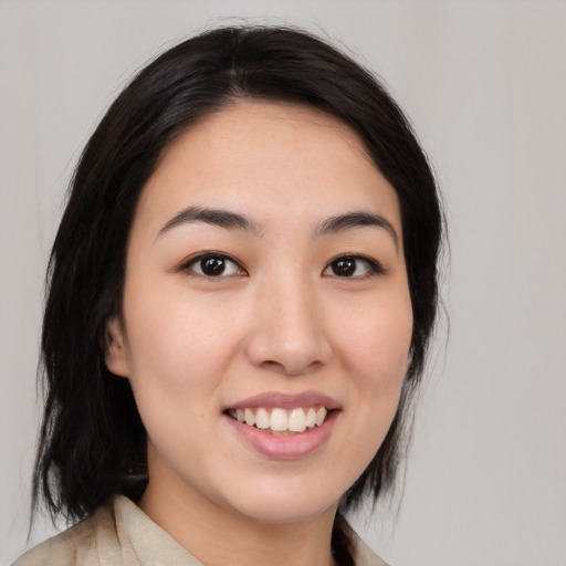 Joyful white young-adult female with medium  black hair and brown eyes