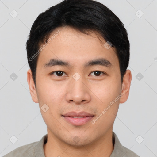 Joyful asian young-adult male with short  brown hair and brown eyes