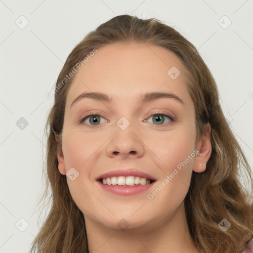 Joyful white young-adult female with long  brown hair and green eyes