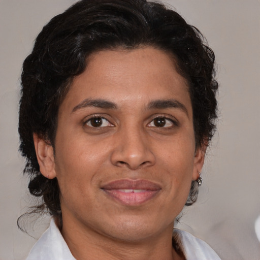 Joyful black adult female with medium  brown hair and brown eyes