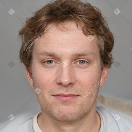 Joyful white adult male with short  brown hair and grey eyes