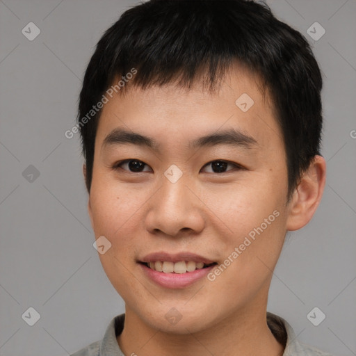 Joyful asian young-adult male with short  brown hair and brown eyes