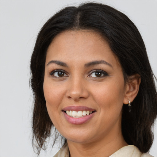 Joyful latino young-adult female with medium  brown hair and brown eyes