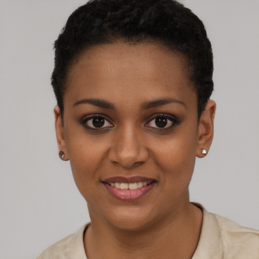 Joyful black young-adult female with short  black hair and brown eyes