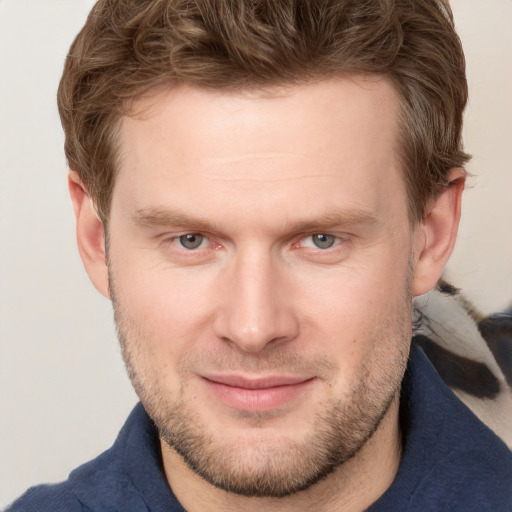 Joyful white adult male with short  brown hair and grey eyes