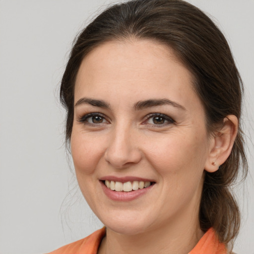 Joyful white young-adult female with medium  brown hair and brown eyes