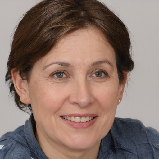 Joyful white adult female with medium  brown hair and brown eyes