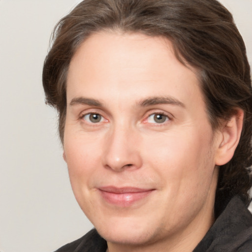 Joyful white adult male with medium  brown hair and grey eyes