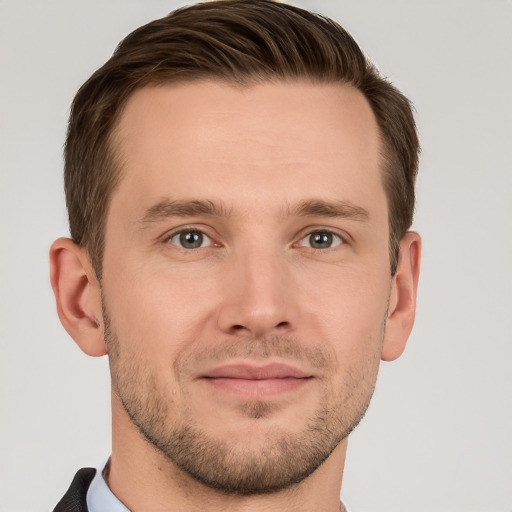 Joyful white young-adult male with short  brown hair and grey eyes