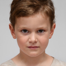 Joyful white child male with short  brown hair and brown eyes