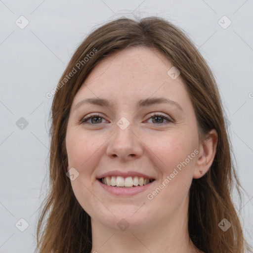 Joyful white young-adult female with long  brown hair and grey eyes