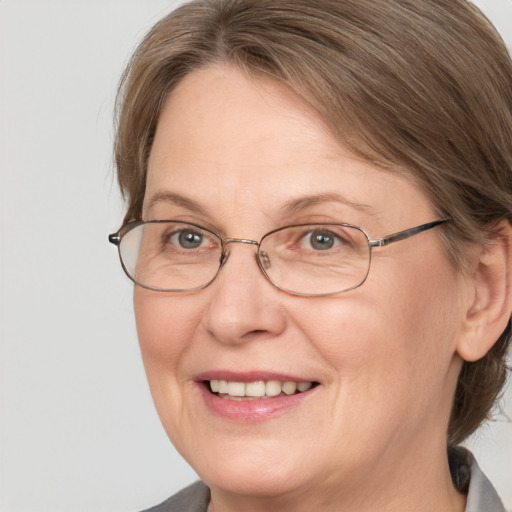 Joyful white middle-aged female with medium  brown hair and grey eyes