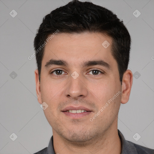 Joyful white young-adult male with short  black hair and brown eyes