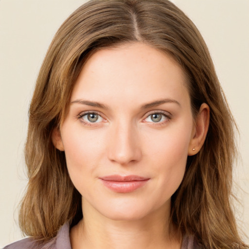 Joyful white young-adult female with long  brown hair and green eyes