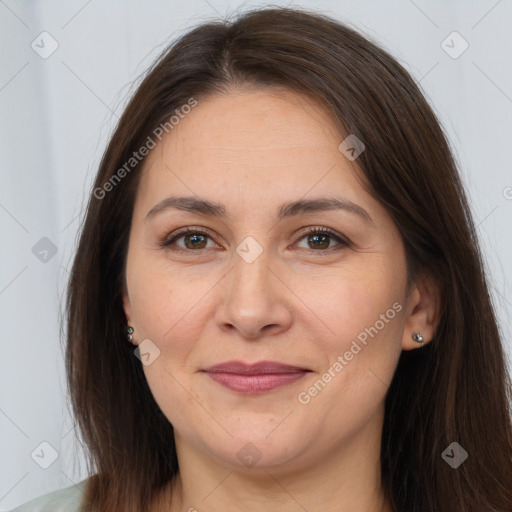 Joyful white adult female with long  brown hair and brown eyes