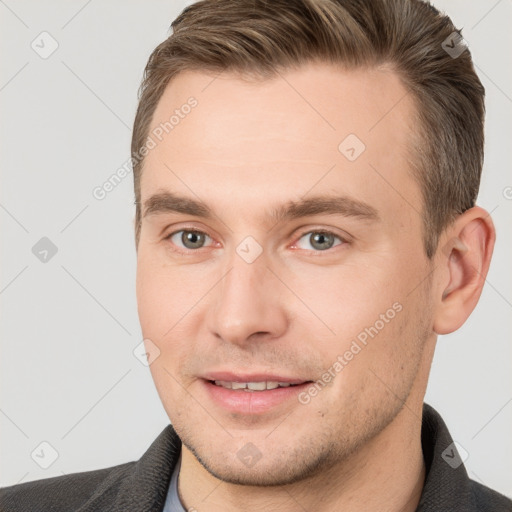 Joyful white young-adult male with short  brown hair and brown eyes