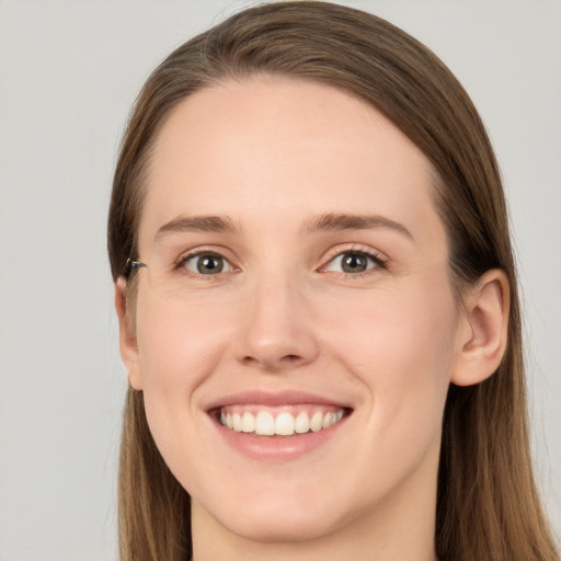 Joyful white young-adult female with long  brown hair and grey eyes